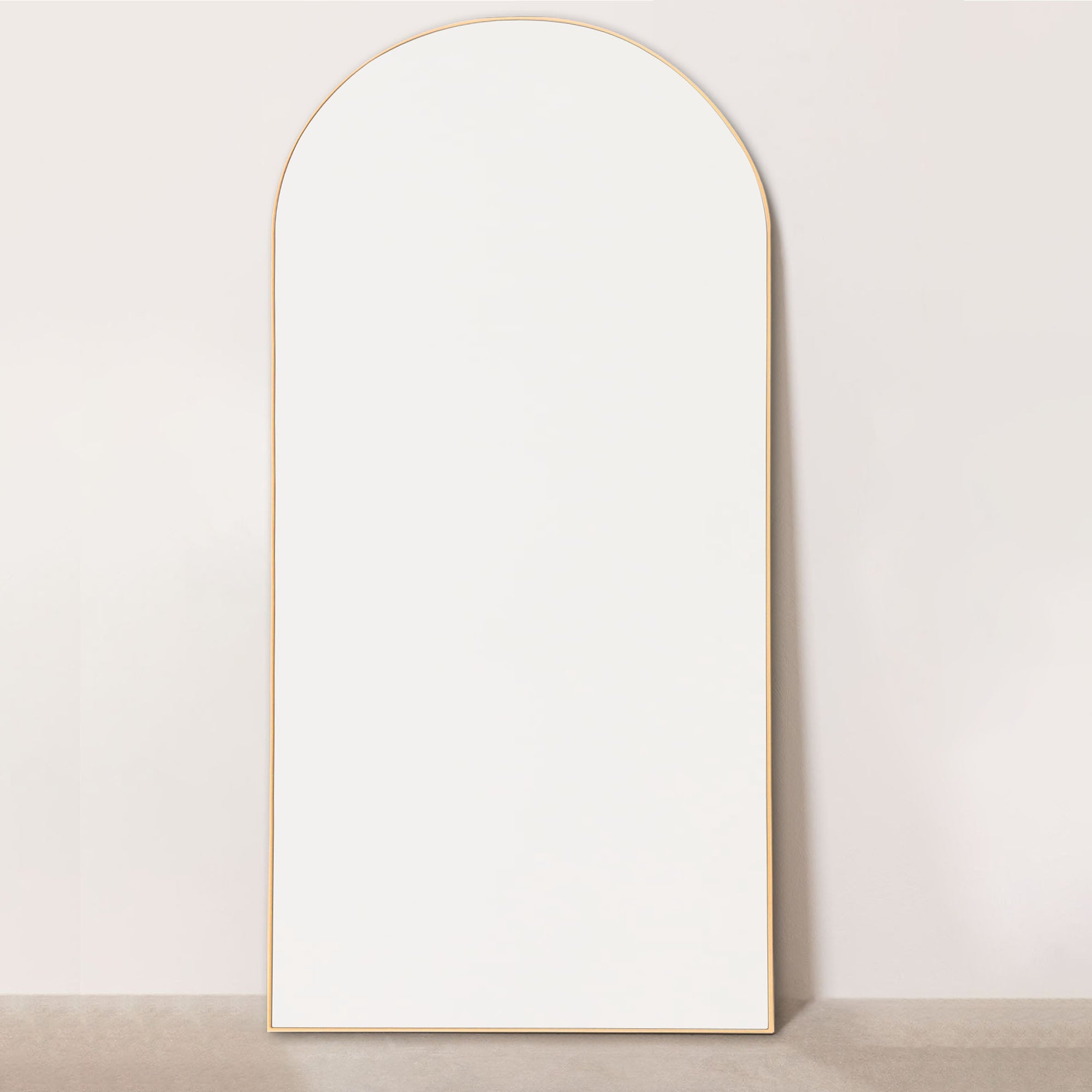 gold wood frame arch leaning mirror