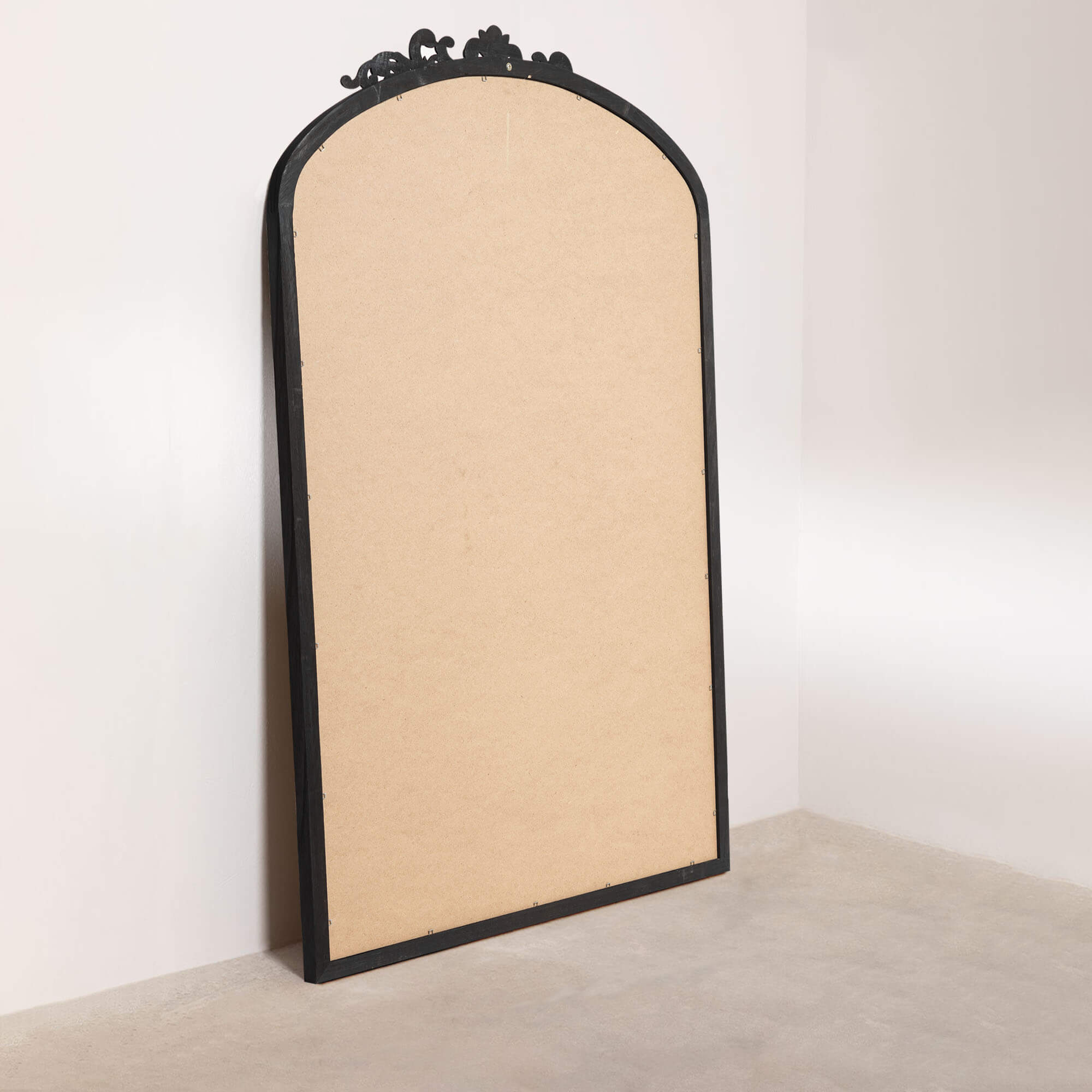 black wood arch leaning mirror